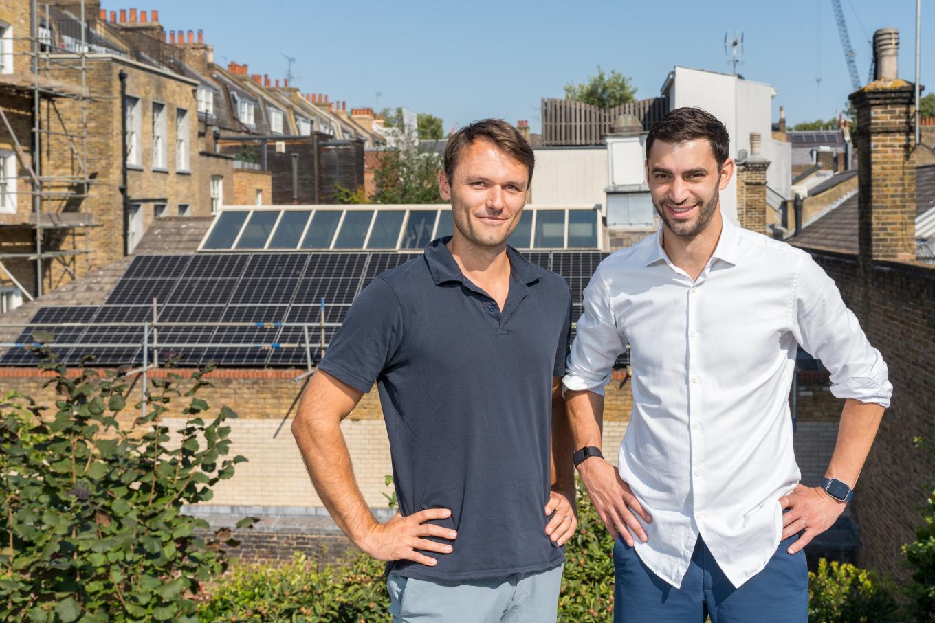 Dan Levene, co-founder of Two Blues Solar, a solar panel installation business standing in front of solar panels