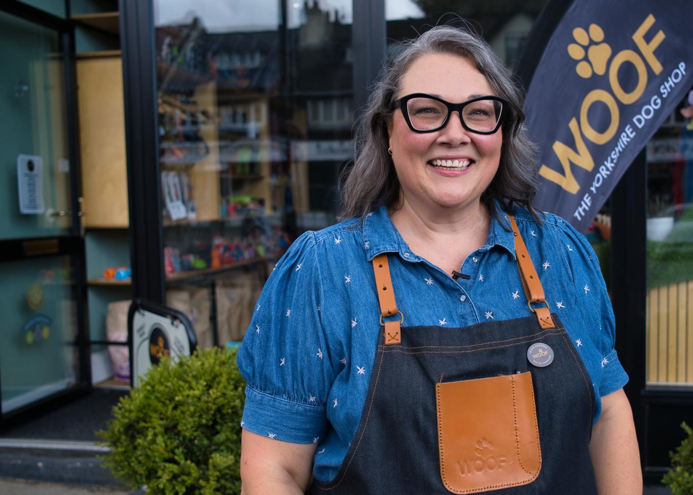 Business owner of Woof The Yorkshire Dog Shop standing in front of her business